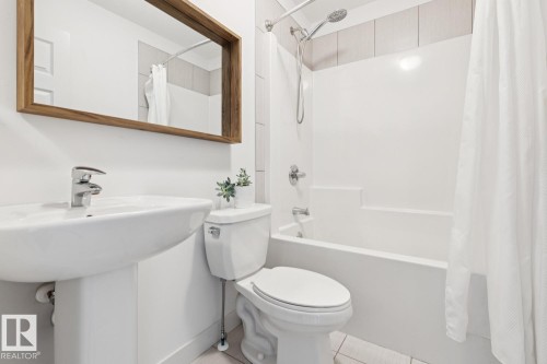 White pedestal sink with a chrome faucet - 22434 99A Avenue Nw, Edmonton, AB 