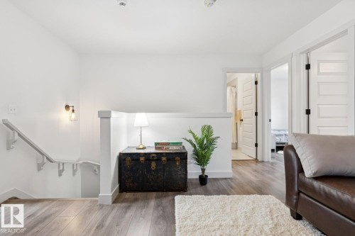 Wood-finish flooring throughout, white walls, and modern interior doors - 22434 99A Avenue Nw, Edmonton, AB 