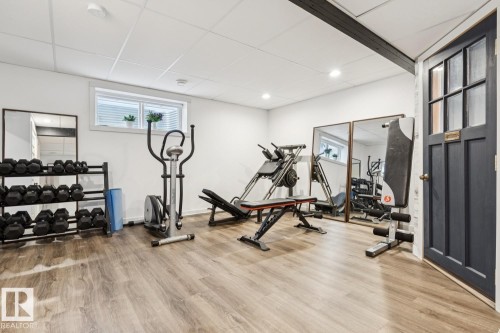 Wood-finish flooring, recessed lighting, white walls, and a visible window with blinds - 22434 99A Avenue Nw, Edmonton, AB 