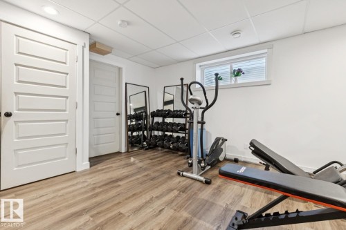 Recessed lighting illuminates wood-finish flooring - 22434 99A Avenue Nw, Edmonton, AB 
