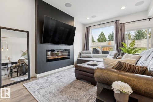 Accent wall featuring a modern linear fireplace - 22434 99A Avenue Nw, Edmonton, AB 