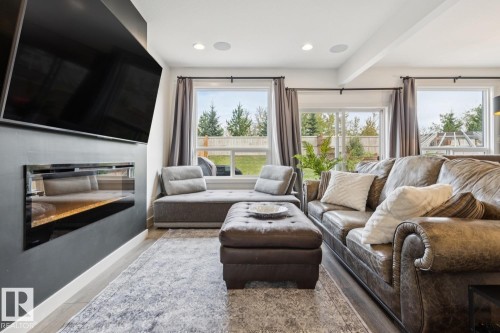 Recessed lighting, wood-finish flooring, and multiple windows with outdoor landscaping - 22434 99A Avenue Nw, Edmonton, AB 