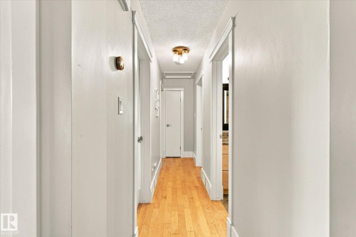 Hardwood flooring, brass ceiling light fixture, white interior doors, and white trim - 3 Akins Drive, St. Albert, AB 