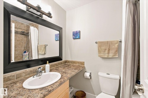 Spacious vanity with a laminate countertop, undermount sink, and chrome faucet - 3 Akins Drive, St. Albert, AB 