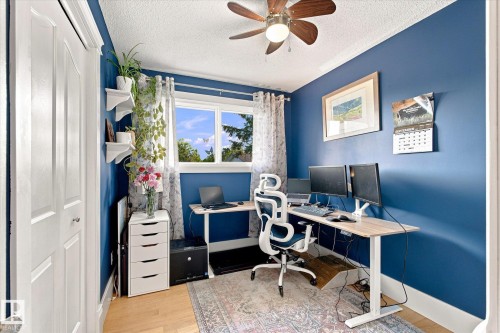 Bright room featuring an exterior window, wood-finish flooring, white trim, and a ceiling fan - 3 Akins Drive, St. Albert, AB 