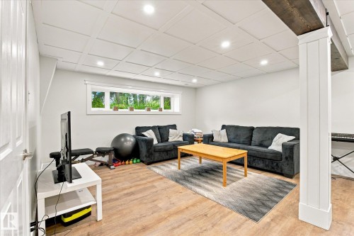 Wood-finish flooring, recessed lighting, coffered ceiling, exposed wood beam, and a horizontal window - 3 Akins Drive, St. Albert, AB 