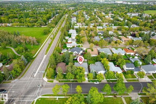 Aerial perspective showcasing residential properties, tree-lined streets, and expansive green spaces - 3 Akins Drive, St. Albert, AB 
