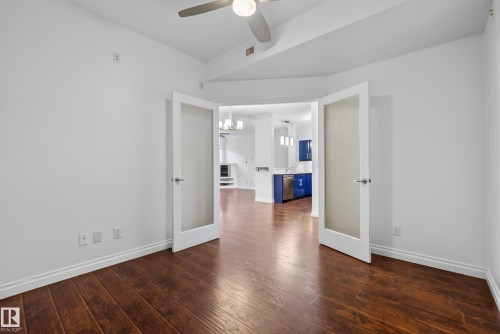 Wood-finish flooring, white walls, and a ceiling fan - #210 10121 80 Av Nw, Edmonton, AB 