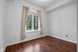 Crisp white walls, wood-finish flooring, and a window with white trim - 