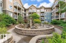 Multi-story building with stone veneer accents and private balconies - #210 10121 80 Av Nw, Edmonton, AB 