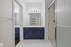 Vanity with blue cabinetry, white countertop, and integrated sink - 