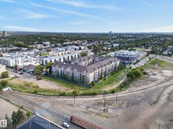 Aerial perspective of a mixed-use urban landscape featuring residential buildings and commercial establishments - 