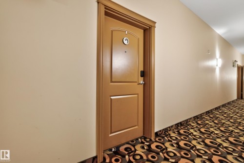 Wood-finish door with smart lock entry - #210 10121 80 Av Nw, Edmonton, AB 