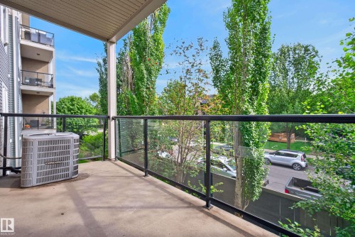 Outdoor balcony with concrete flooring and glass panel railing - #210 10121 80 Av Nw, Edmonton, AB 