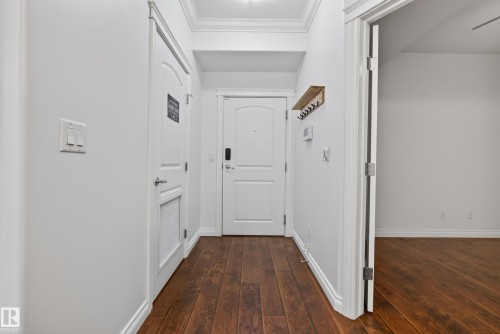 Wood-finish flooring throughout, crown molding, and white trim - #210 10121 80 Av Nw, Edmonton, AB 
