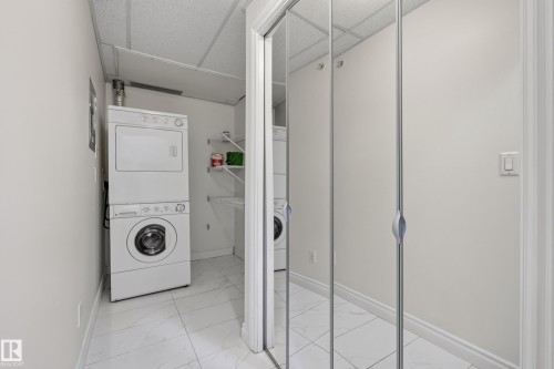 Stackable laundry appliances, wire shelving, and mirrored closet doors - #210 10121 80 Av Nw, Edmonton, AB 
