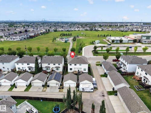 Aerial perspective showcasing the residential neighborhood with a large green space - 483 Watt Boulevard Sw, Edmonton, AB 