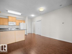 Kitchen with wood-finish cabinetry, stainless steel appliances, and a breakfast bar - 