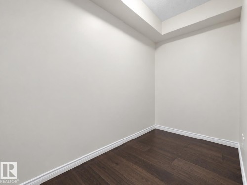 Den or storage space..Wood-finish flooring with white trim and neutral wall tones - #116 16807 100 Av Nw, Edmonton, AB 