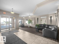 Tiled flooring entry transitioning to carpet, recessed lighting, and wall sconces - 