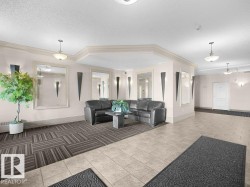 Neutral-toned tile flooring, wall-mounted sconces, pendant lighting, mirrored wall accents, and ceiling crown molding - 