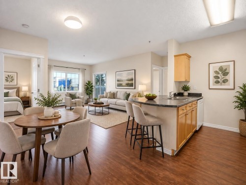 AI GENERATED PHOTO-Open-concept living area with wood-finish flooring, a kitchen island with seating, light wood cabinetry, and a double window - #116 16807 100 Av Nw, Edmonton, AB 