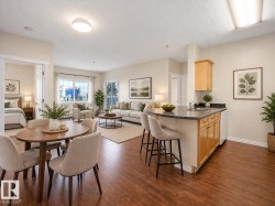 AI GENERATED PHOTO-Open-concept living area with wood-finish flooring, a kitchen island with seating, light wood cabinetry, and a double window - 