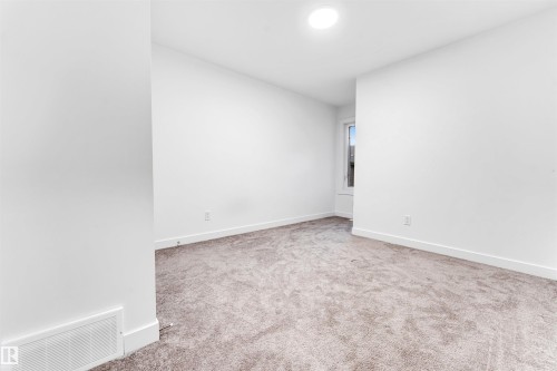 Plush carpeting, bright white walls, recessed ceiling lighting, and a single window - #45 2710 66 St Sw, Edmonton, AB 
