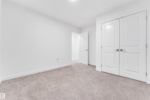 Neutral-toned carpeting, white walls, and bright overhead lighting - #45 2710 66 St Sw, Edmonton, AB 