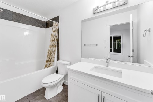White vanity with an integrated rectangular sink, chrome faucet, and quartz countertop - #45 2710 66 St Sw, Edmonton, AB 