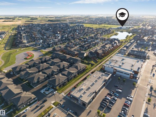 Residential community featuring varied housing styles, commercial retail spaces, and a central pond - #45 2710 66 St Sw, Edmonton, AB 