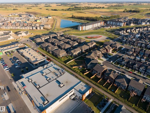 New construction residential properties situated within a developed community featuring commercial spaces and a water feature - #45 2710 66 St Sw, Edmonton, AB 