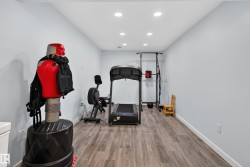 Recessed ceiling lighting, light-toned walls, and wood-finish flooring - 
