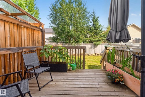 Wood-plank deck with railing, integrated planters, and a privacy fence - 17363 120 Street Nw, Edmonton, AB 