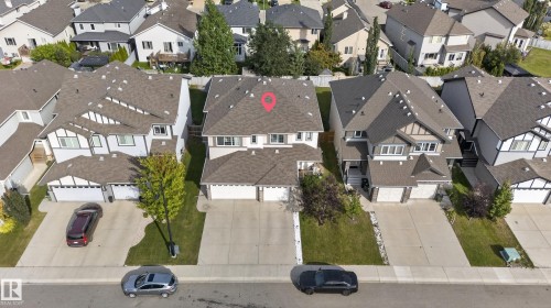 Two-story property with a dual-car garage, concrete driveway, and landscaped front yard - 17363 120 Street Nw, Edmonton, AB 