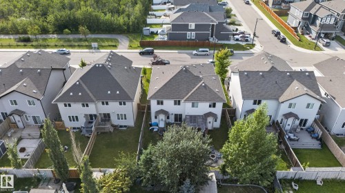 Two-story residence with a gabled roof, light-toned siding, and multiple rear windows - 17363 120 Street Nw, Edmonton, AB 