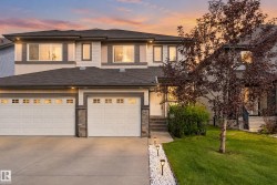 Two-story exterior with light-toned siding and dark trim accents - 