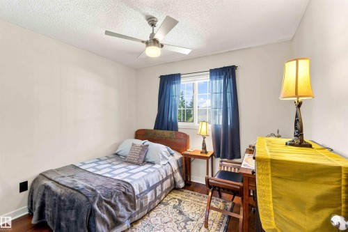 Hardwood-finish flooring, a window with natural light, and a ceiling fan with integrated lighting - #6 15 Poirier Av, St. Albert, AB 