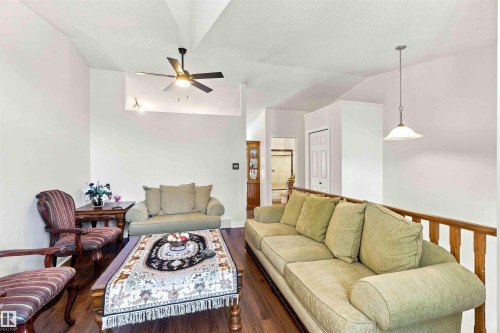 Vaulted ceiling, wood-finish flooring, ceiling fan, pendant lighting, and wood railing - #6 15 Poirier Av, St. Albert, AB 