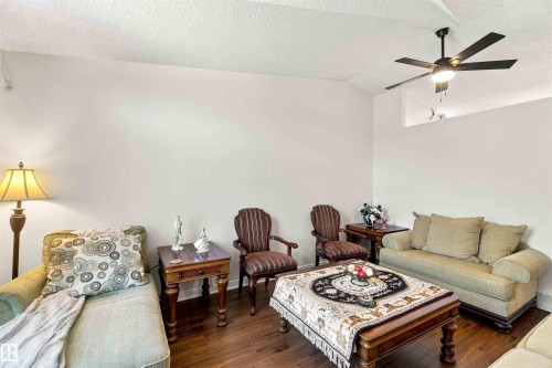 Vaulted ceilings with a ceiling fan, wood-finish flooring, and a decorative niche - #6 15 Poirier Av, St. Albert, AB 