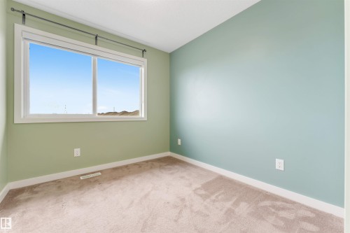 Wall-to-wall carpeting and neutral wall paint - 3340 15A Avenue Nw, Edmonton, AB 