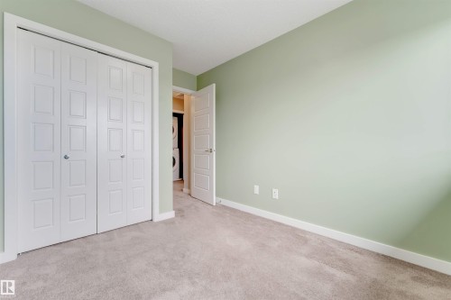 Light-colored carpeting with painted walls and white trim - 3340 15A Avenue Nw, Edmonton, AB 