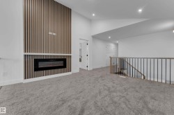 Accent wall featuring vertical wood paneling and a linear electric fireplace - 
