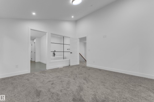 White walls, recessed lighting, and a modern ceiling fixture - 236 Linden Loop, Leduc, AB 