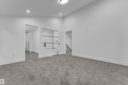 White walls, recessed lighting, and a modern ceiling fixture - 