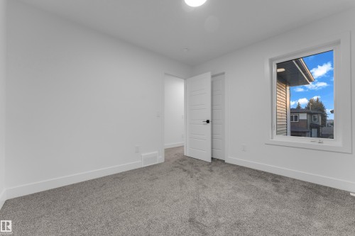 Neutral wall color, grey carpet flooring, white trim, modern interior door, and a single window - 236 Linden Loop, Leduc, AB 