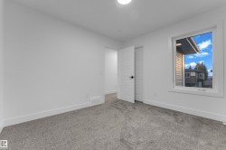 Neutral wall color, grey carpet flooring, white trim, modern interior door, and a single window - 