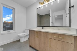 Wood-finish vanity with gold-tone hardware and a white countertop - 