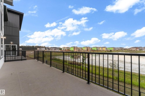 Expansive concrete balcony with black metal railings - 236 Linden Loop, Leduc, AB 