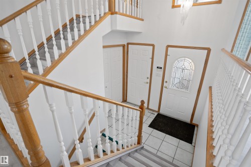 Two-story staircase with wood-finish handrails and white balusters - 2915 151A Avenue Nw, Edmonton, AB 